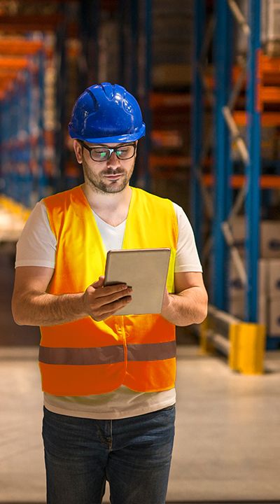 Warehouse supervisor checking stock on a tablet